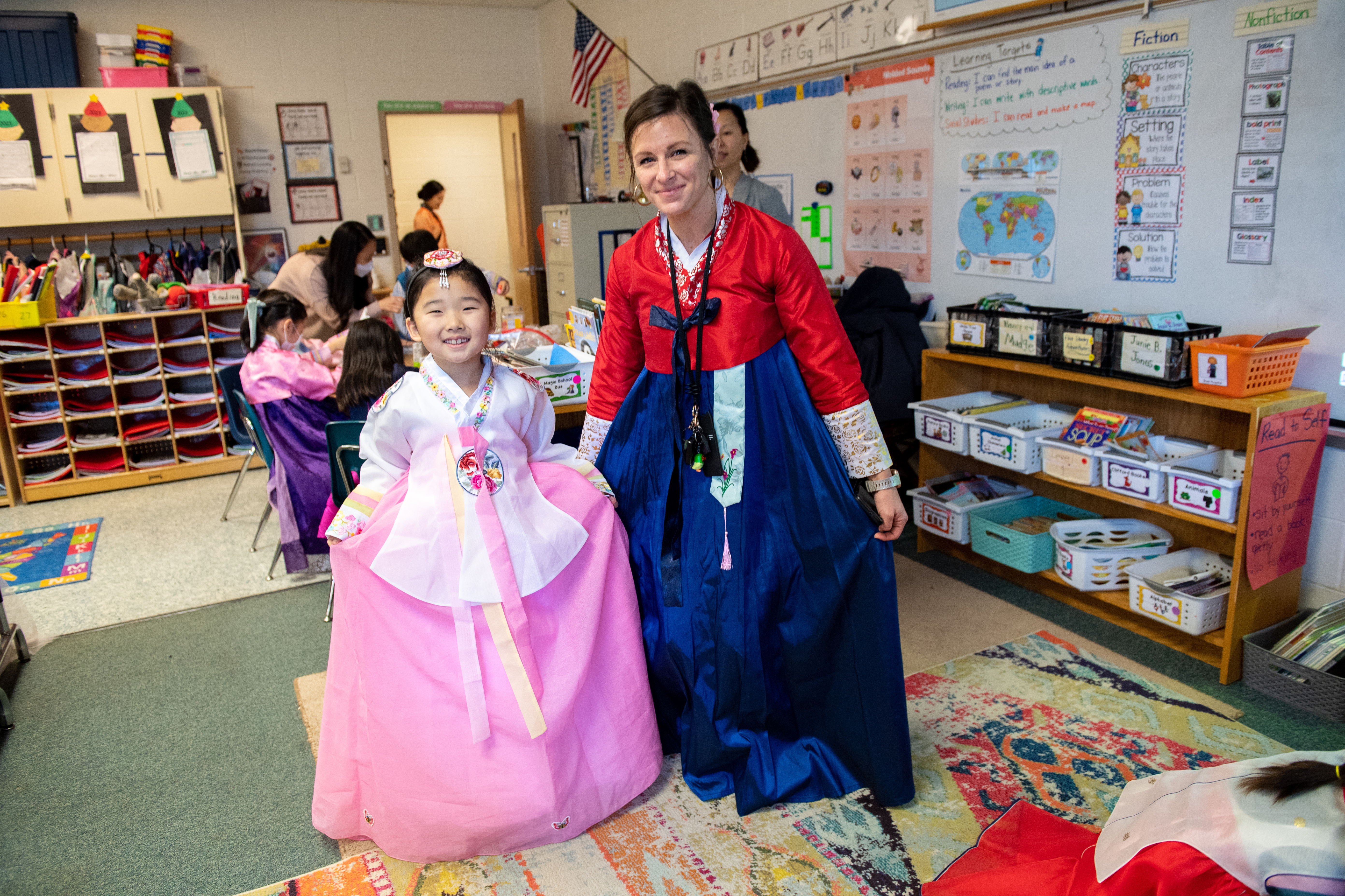 A Powell student and teacher wear hanboks, or traditional Korean dress, at schoolwide festivities to honor the Lunar New Year.