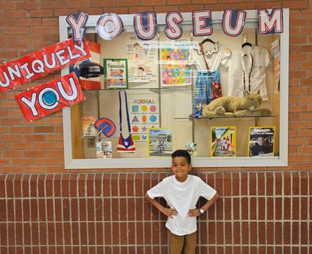 student with his Uniquely You Youseum display